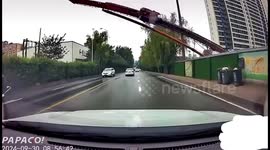 Terrifying moment giant drilling rig collapses onto busy road in China as drivers slam brakes to avoid disaster