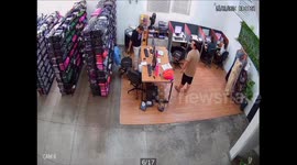 Comedic scene as man knocks over rows and rows of shelves