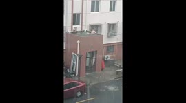 Man seen relaxing in accumulated rainwater on rooftop in Shanghai