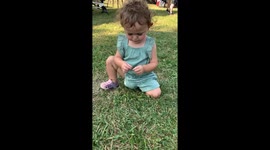 Child plays quietly in grass until asked about activity in Crown Point