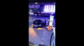 Petrol station worker extinguishes fire from burning fog light