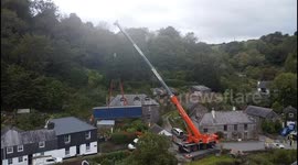 Drone captures truck stuck in narrow road in Cornish village for three days
