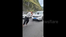 Stuck in holiday traffic jam for hours, jolly motorist entertains fellow drivers by dancing on highway in China