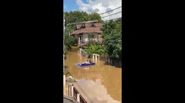 Hilarious pair repeatedly crash kayak while negotiating flooded road
