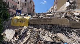 Picture of Hassan Nasrallah over the rubble of a residential building in Dahieh suburb