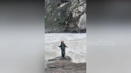 Young woman criticised for posing for pictures by raging flood in China