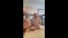 Child laughs hysterically at sound of unrolling tape