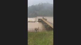 Pontoon Boat Goes Over Flooded Dam in Virginia
