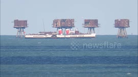 World's last seagoing paddle steamer seen with historic Thames forts off Kent, UK