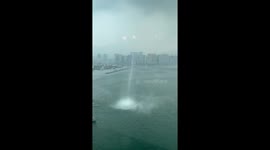 Terrifying waterspout tornado rips through sea towards buildings