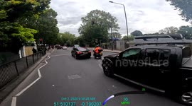 Cyclist jumps the red light and almost hits a pedestrian. He does not even apologise to her.