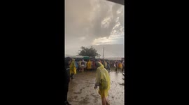 Person hides in trash bin to escape heavy rain at Negrita Music Festival, Spain