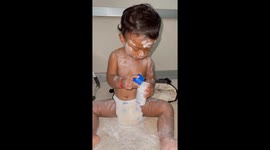 Toddler covers himself in baby powder he took from table
