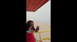 Man Doesn't Let Rain Ruin His Beach Day