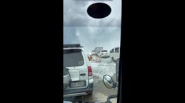 Huge waves crash into cars boarding ferry