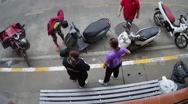 Snake jumps out of motorcycle leaving onlookers in panic