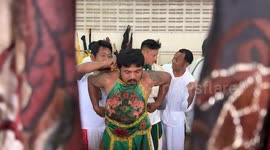 Devotees skewer their cheeks with bizarre items at Vegetarian Festival in Thailand