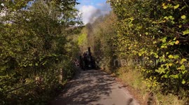 Travelling the old fashioned way. Vintage steam engine climbing the steep hill towards Monsal Head in Derbyshire UK in 4K with sound.