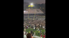 Crowd dismantle goal posts after college American football game