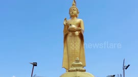 Dozens of golden giant Buddhas and dragons are housed in this Thai temple