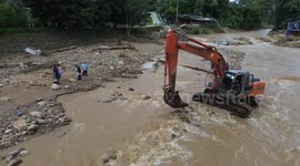 Excavator carries pregnant woman across river when she goes into labour