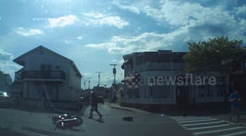 Motorcyclist miraculously stays on feet after getting smashed by car
