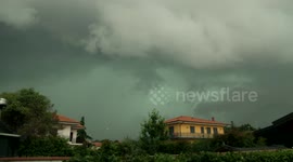 Storm passes over town on the slopes of Mount Etna