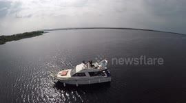 Romantic boat arrival to wedding reception with drone crash