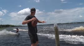 Astonishing video shows wakeboarder catching football while backflipping