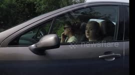 07 in Swords woman driving on the phone with her 2 kids in the car