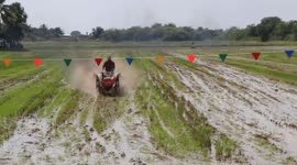 Tractor drivers race through paddy fields in Thailand