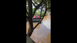 Chilled resident floats on sofa along flooded road