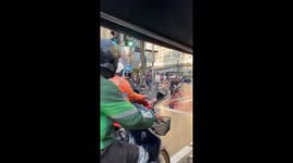 Young woman seen negotiating busy junction on electric suitcase