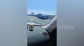 Bizarre moment driver carries on despite bonnet open completely obscuring view