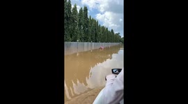 Coffin floats down the street during floods in northern Thailand