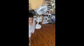 Baby brother adorably buried in toys as he swings in hammock