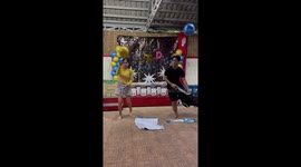 Teachers put clothes on while keeping balloon in the air for party game