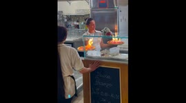 Brave diners dig into flaming pizza served in Italy