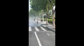 Leaky fire hydrant sprays water across road in China