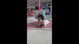 Child lays unbothered as plush toys spin by