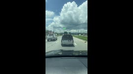 Box lid appears to fly as it comes loose in roof cargo net