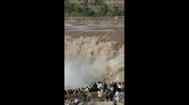 Stunning rainbow arches over roaring Hukou Waterfall