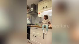 Cheeky tot caught on camera pretending to cry to steal a hug from dad