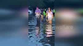 US: Police Officers Saving Lives from Floodwaters at The Standard Apartments