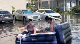 Air bed rowing in Tampa flood after Hurricane Milton
