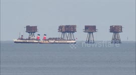 Historic ships parade around Red Sands Forts off Kent, UK