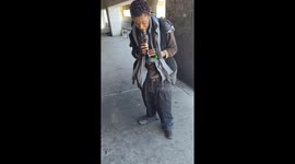 Homeless Man Performs Music Under a Bridge