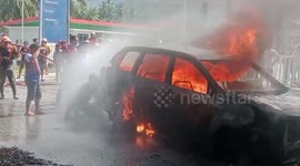 Minibus catches fire injuring driver at petrol station in Indonesia