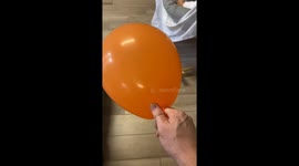 Baby can't stop smiling at dad's hair-raising balloon trick