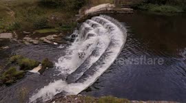 Weir on the river Wye at Monsal head viaduct in Derbyshire UK in 4K